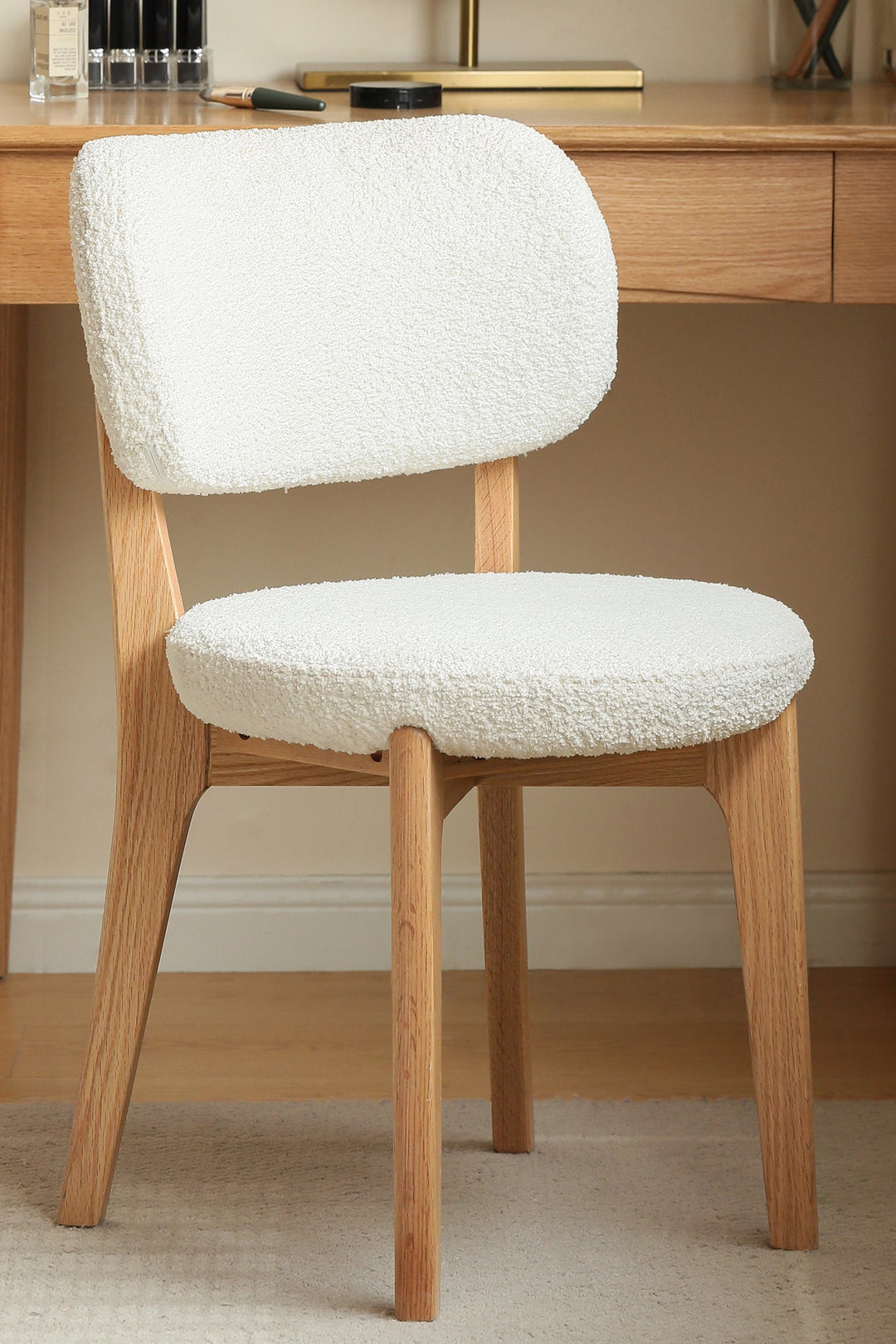 Loop fabric chair with a white cushioned seat and backrest in a room setting. Featured in Loft Home Singapore's fabric chairs collection.