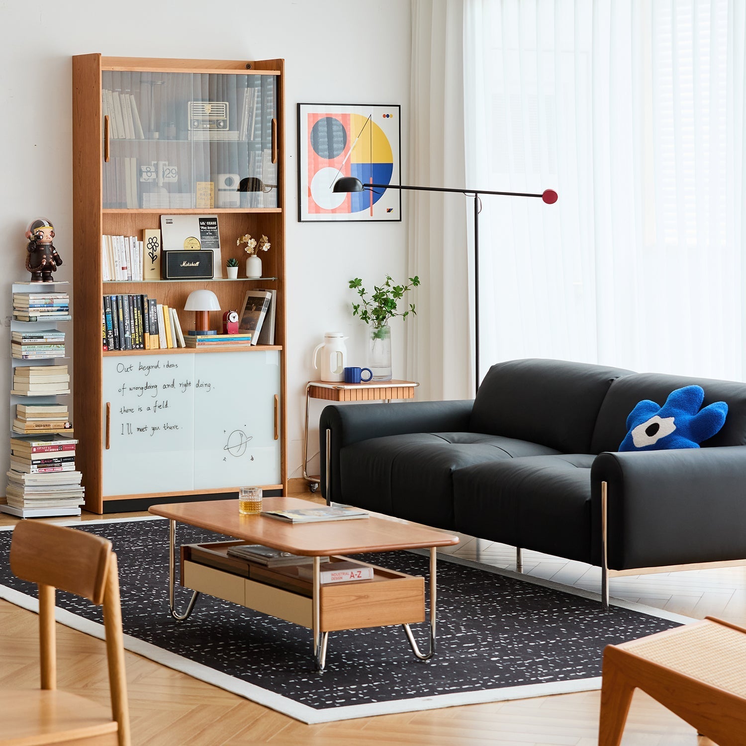 Modern living room setup with black leather sofa, wood coffee table, and display cabinet, featuring Loft Home’s curated space styling inspirations for every room.