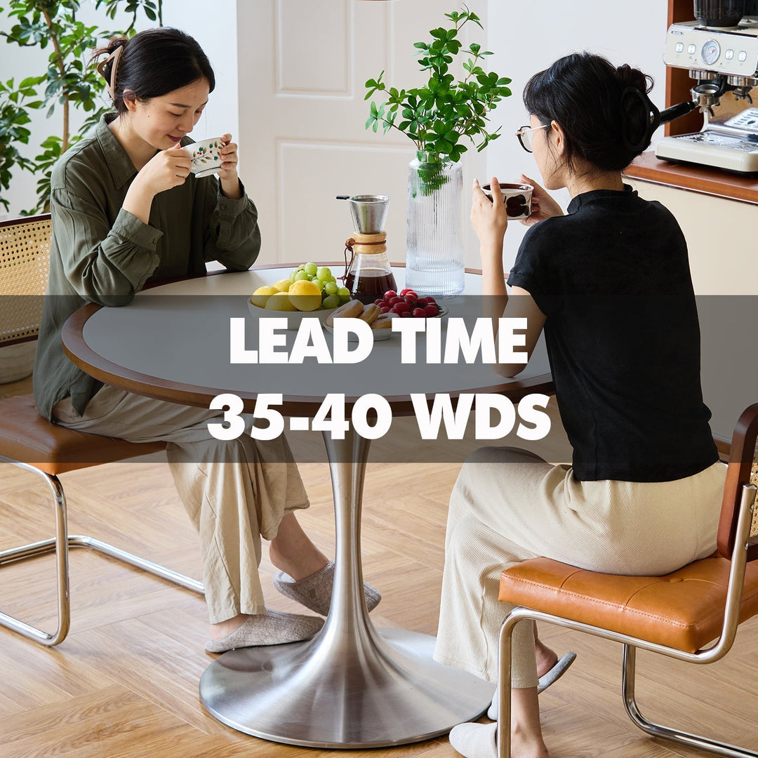 Round metal-base dining table with wood top, paired with retro leather chairs, perfect for cozy tea moments in Loft Home’s 35–40 working days collection.