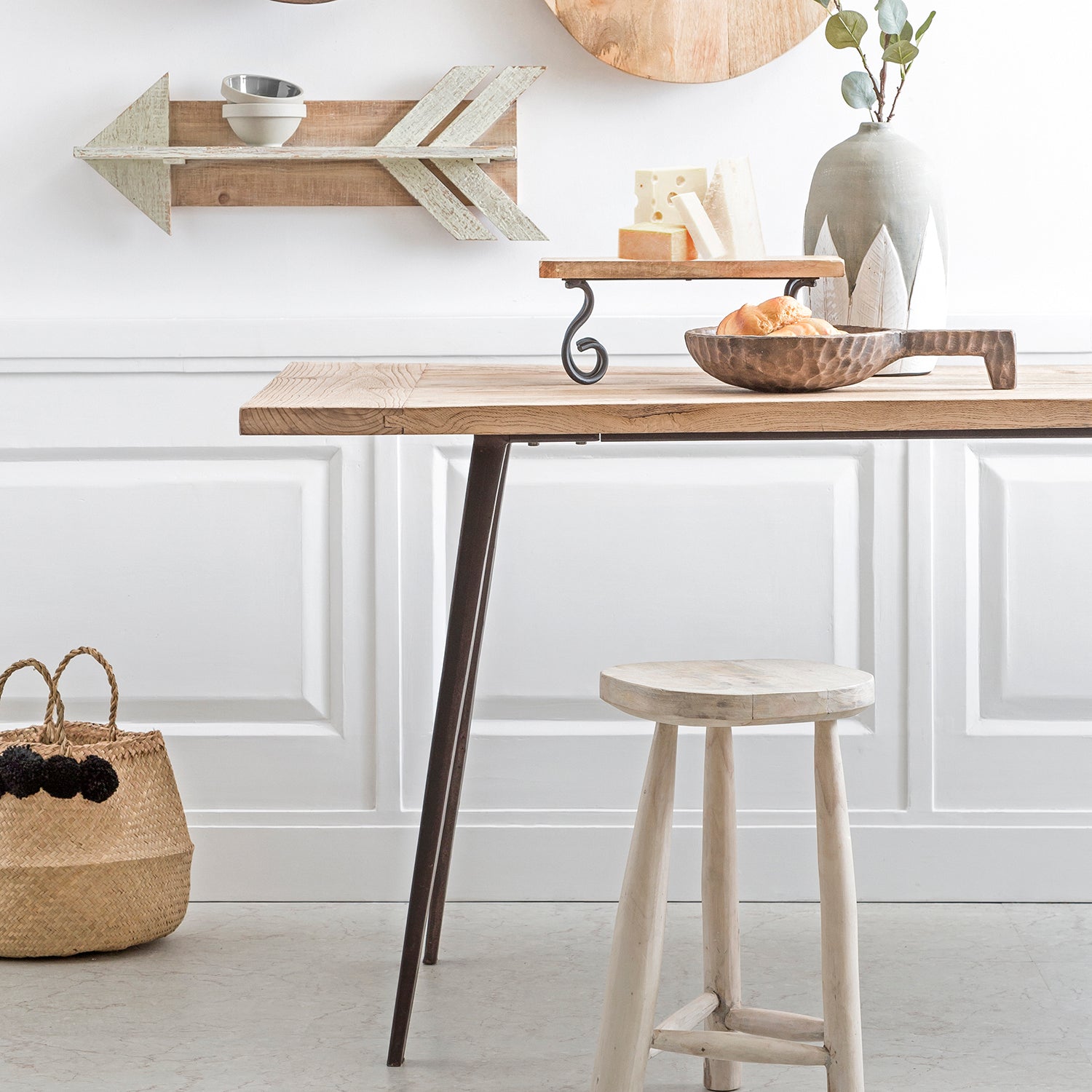 Rustic dining table with a light wood finish, paired with a matching wooden stool, perfect for minimalist and modern interiors. Browse tables collection at Loft Home.