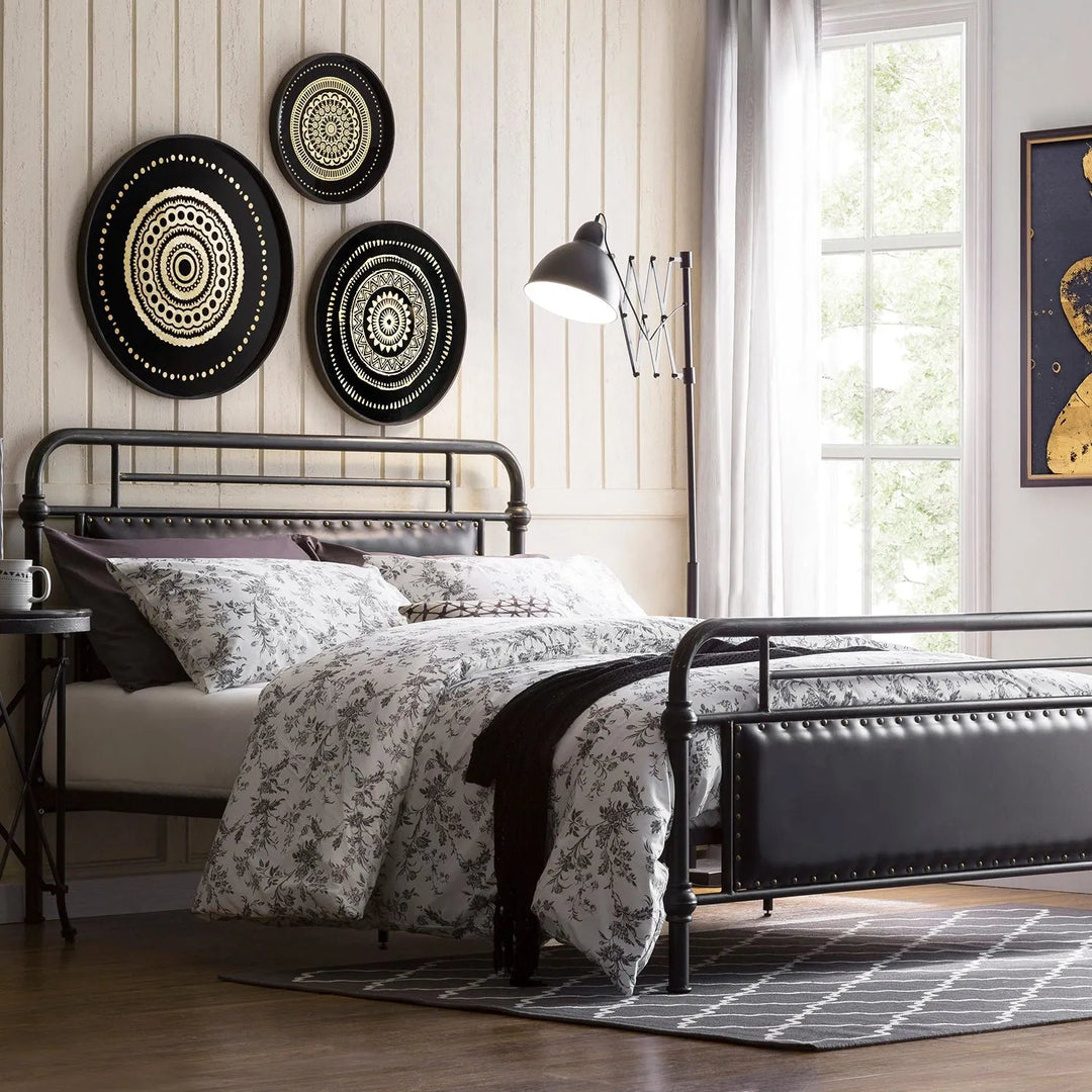 Loft Home metal bed frame with floral bedding, stylish wall decor, and modern lighting in a cozy bedroom with natural light.