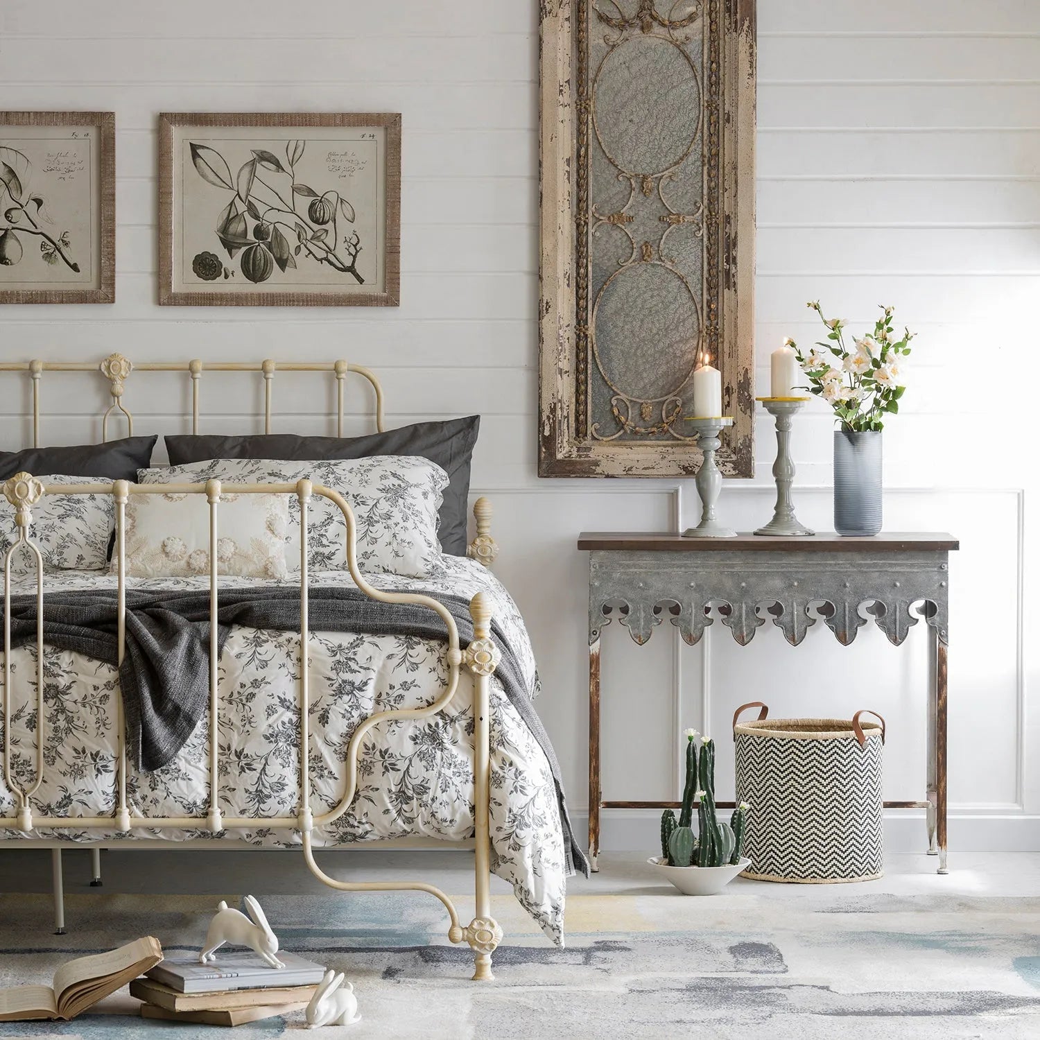 Loft Home vintage-style bedroom with an elegant cream metal bed frame, floral bedding, and rustic decor, creating a cozy and timeless space.