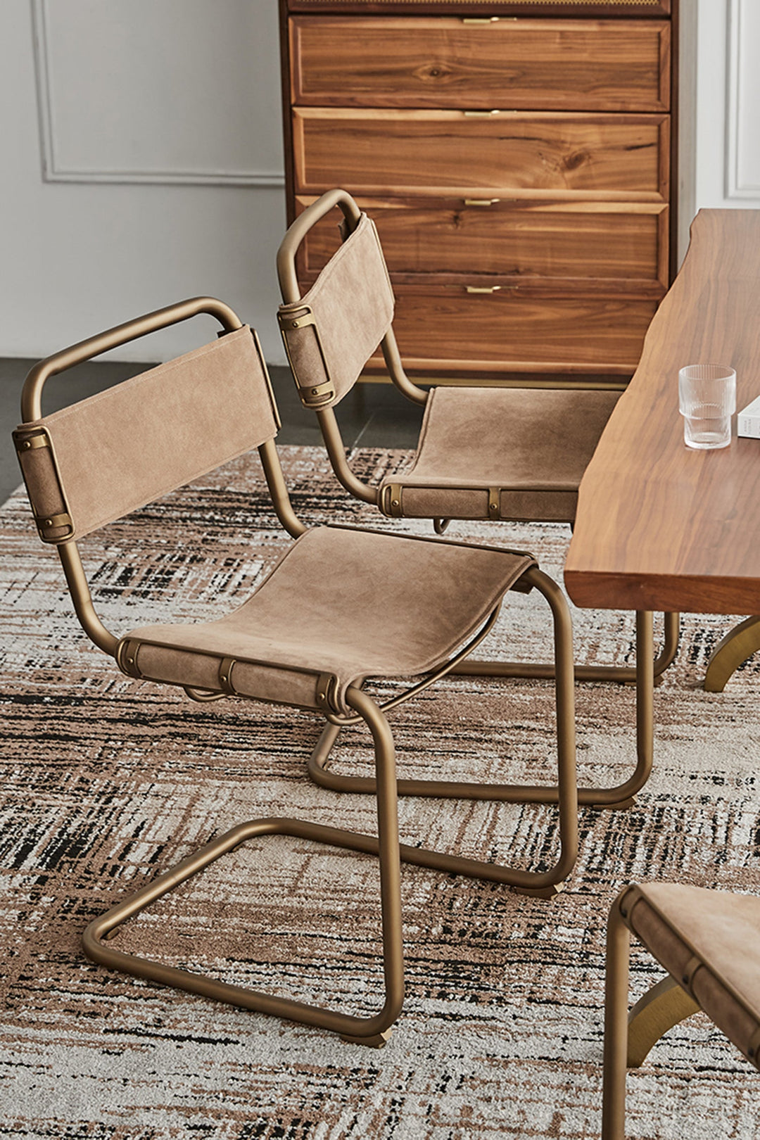 Brass dining chairs with vintage leather seats, styled for modern US dining rooms, apartments, lofts, and industrial interiors.
