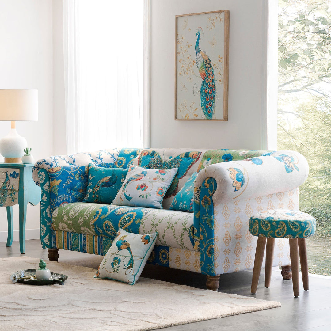 Loft Home contemporary sofa in vibrant floral patterns, paired with matching cushions and stool, elevating modern living spaces with artistic charm.