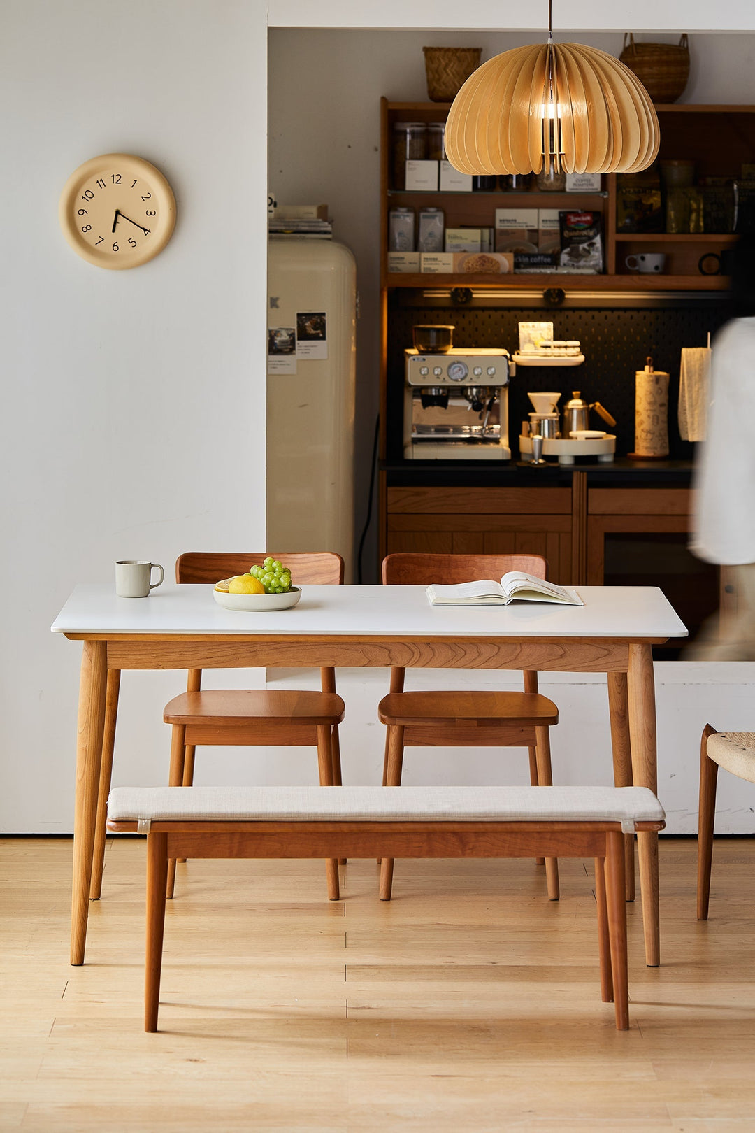 Scandinavian dining table set with solid wood legs and white top, styled in a cozy home café setting.