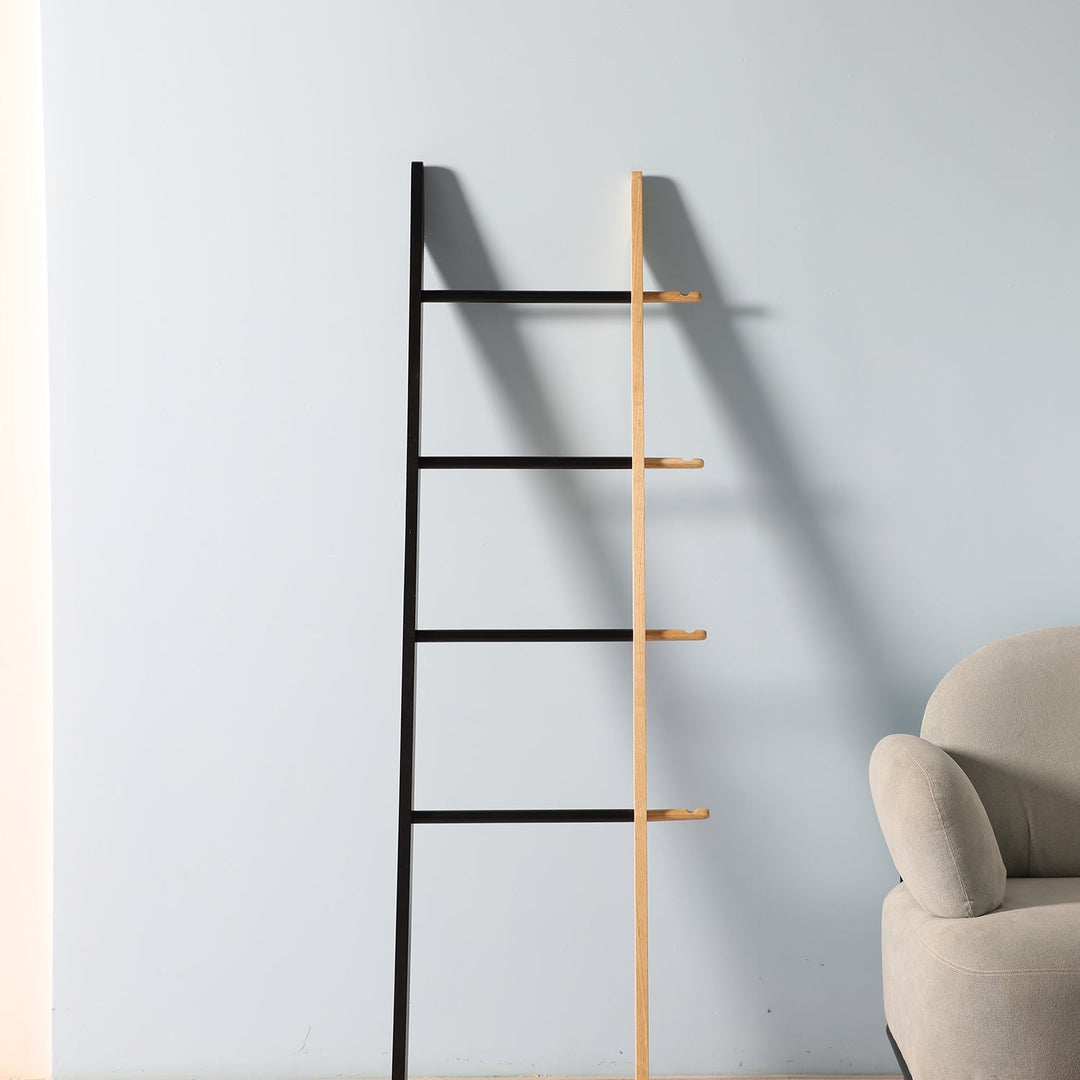 Outdoor clothes hanger with a sleek ladder design in contrasting wood and metal, offering stylish utility for hanging garments in versatile spaces.