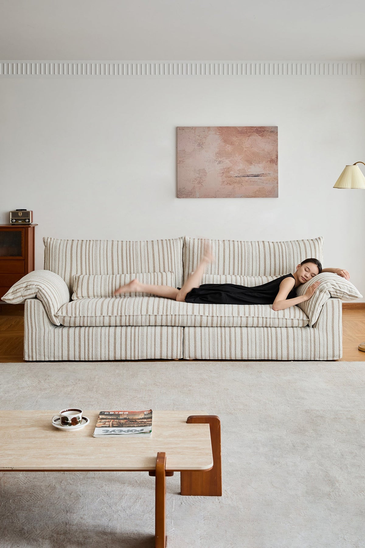 Long striped fabric sofa in a bright living room, designed for lounging, relaxing, and family comfort in modern US homes.