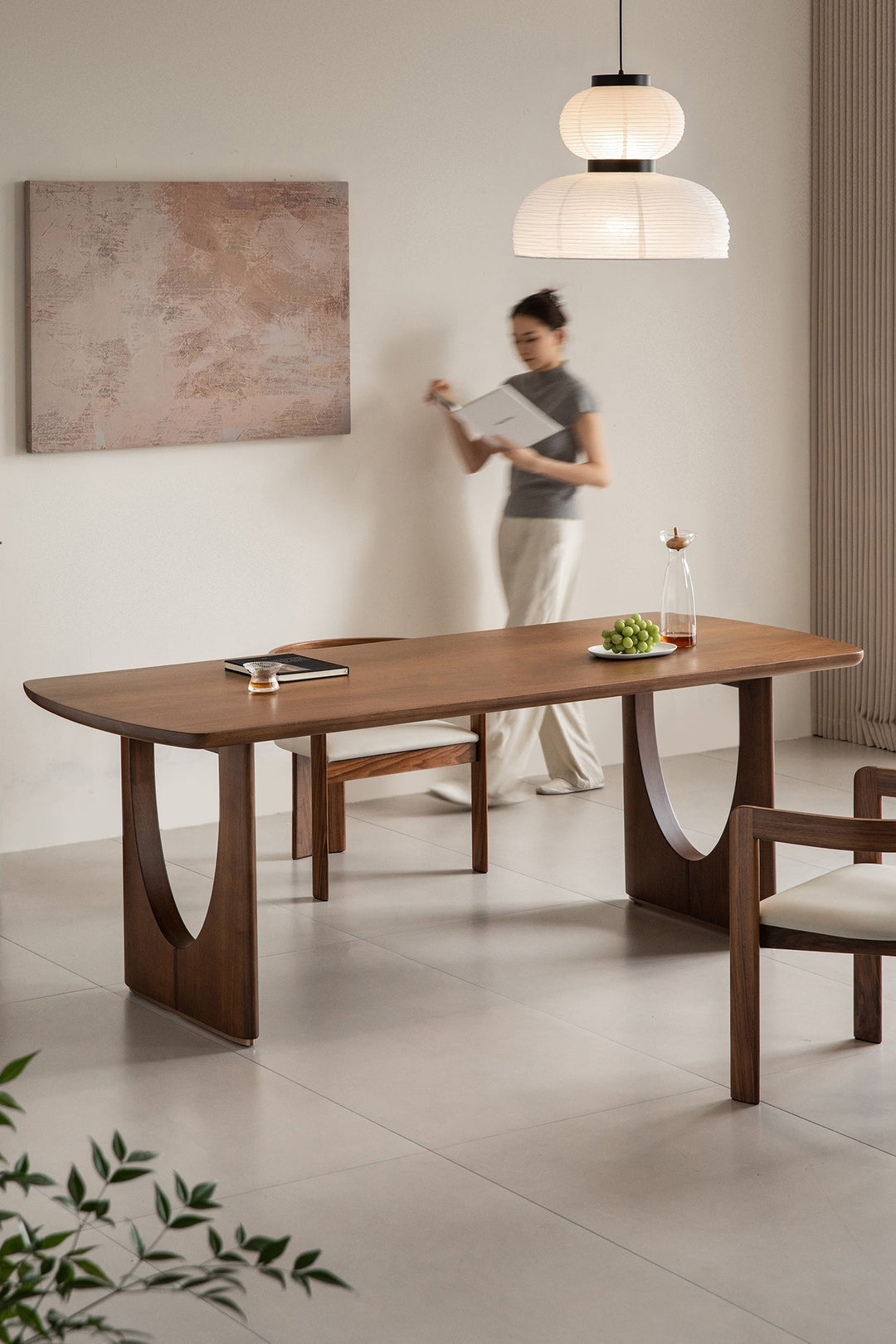 Wabi-sabi premium solid wood dining table with sculptural legs, styled in a serene modern interior, bringing natural elegance to Singapore homes.