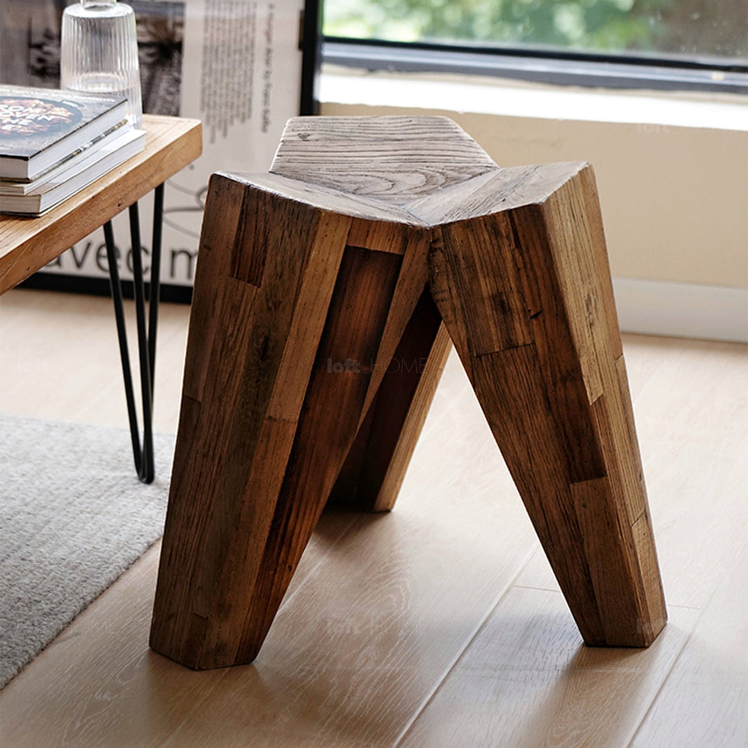 Rustic wooden stool crafted with natural grain patterns, adding warmth and character to modern or traditional interiors.