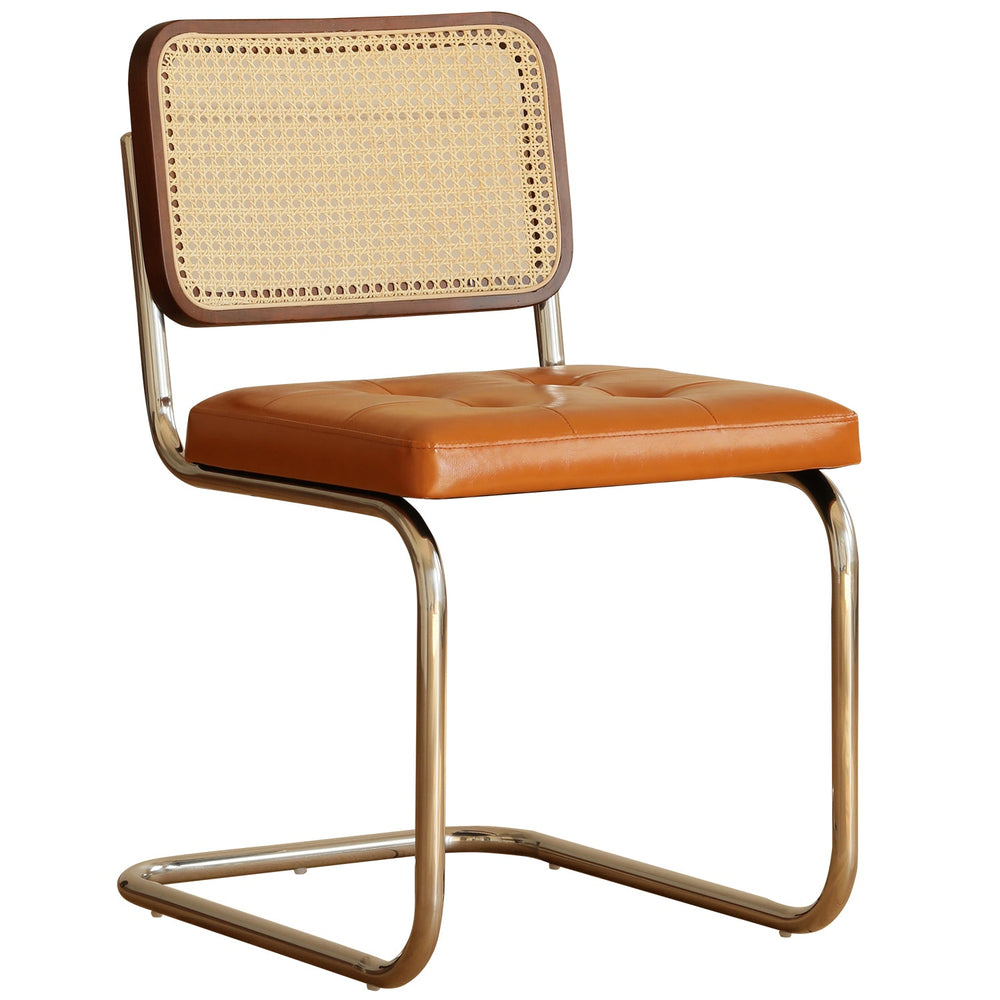 Vintage rattan pu leather dining chair hoh xil in white background.