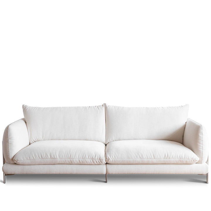 Minimalist cotton fabric 3 seater sofa como in white background.