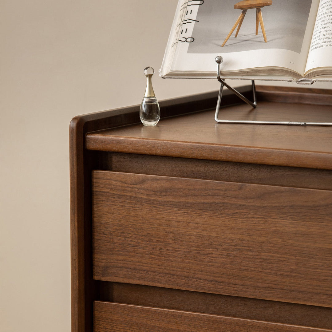 Vintage walnut wood chest of drawers vista with context.
