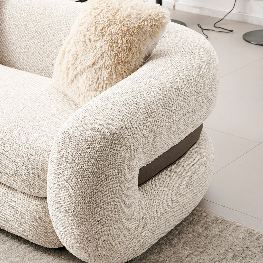 Cream boucle fabric 2 seater sofa curly with context.