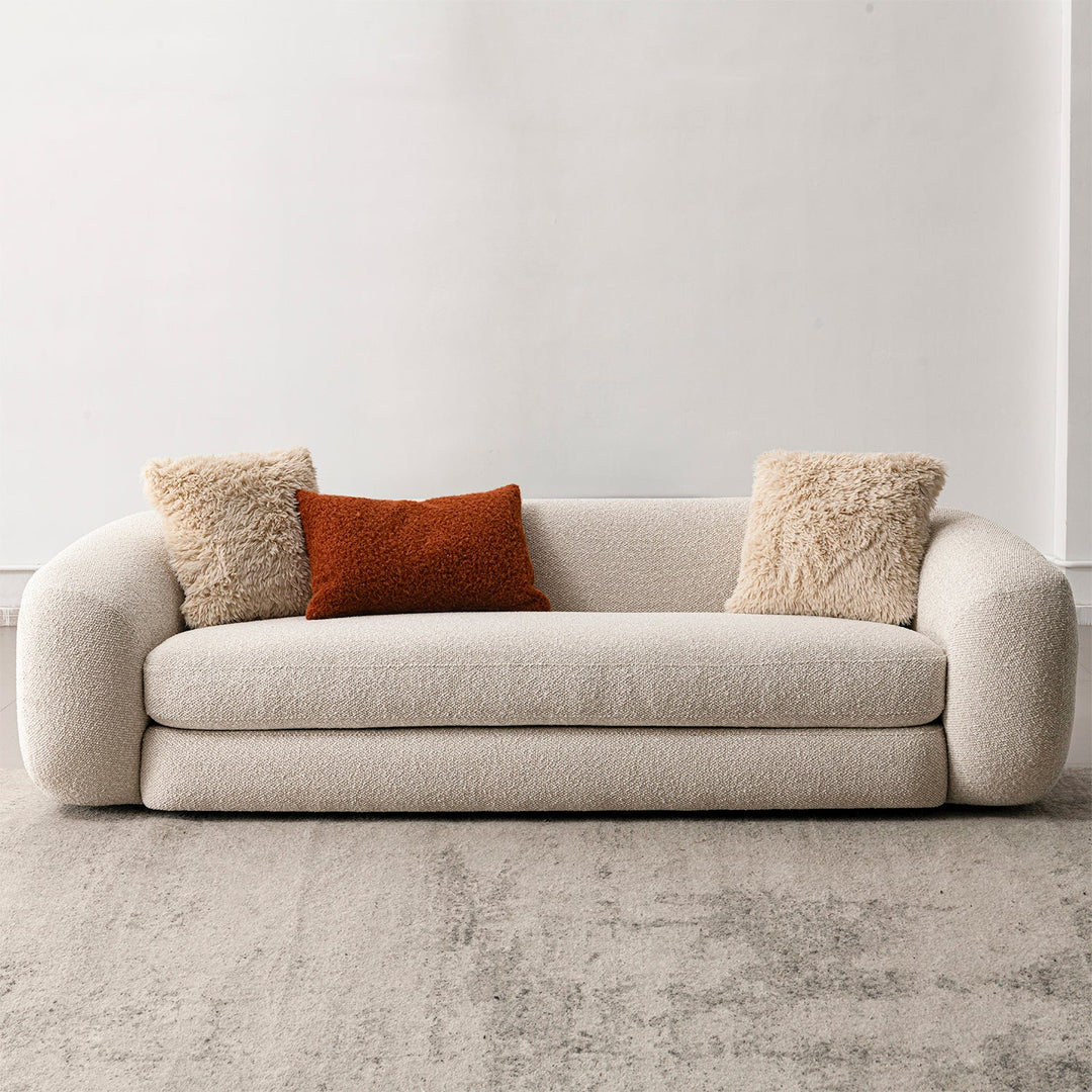 Cream boucle fabric 3 seater sofa curly in panoramic view.