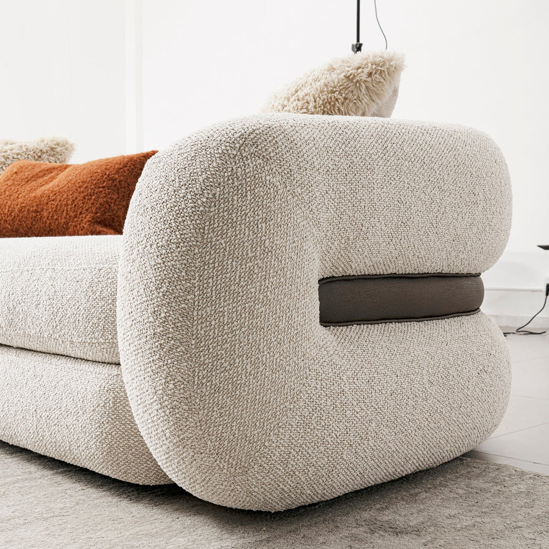 Cream boucle fabric 3 seater sofa curly in close up details.