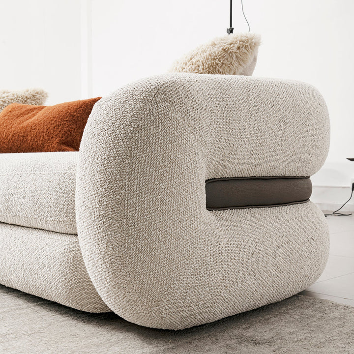 Cream boucle fabric 3 seater sofa curly in close up details.