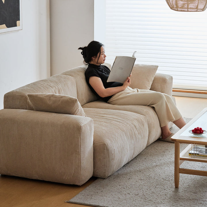Cream corduroy velvet fabric 3 seater sofa square in panoramic view.