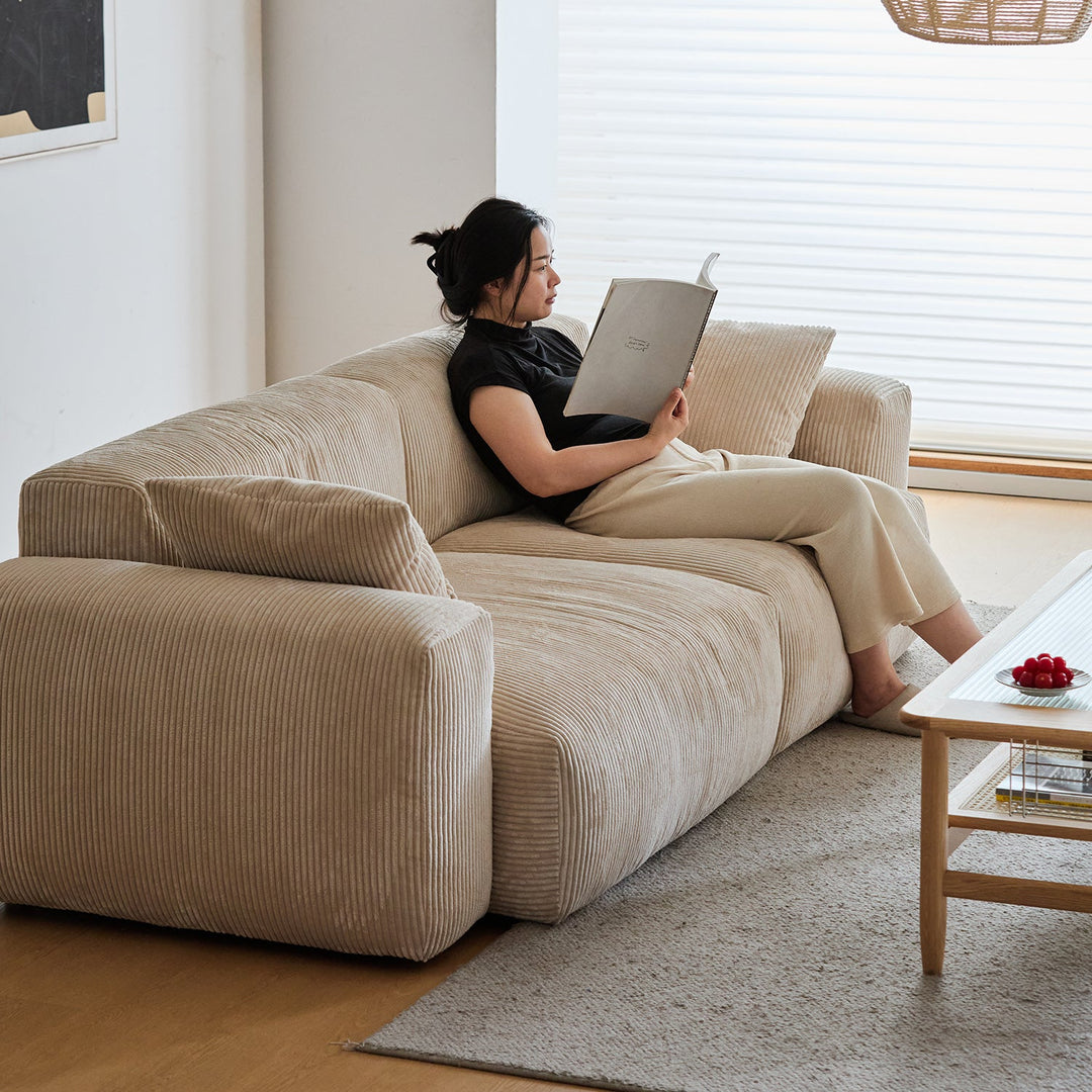 Cream corduroy velvet fabric 4 seater sofa square in panoramic view.
