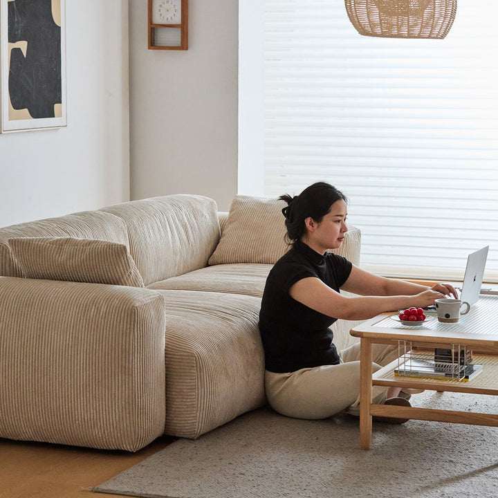 Cream corduroy velvet fabric 4 seater sofa square in still life.