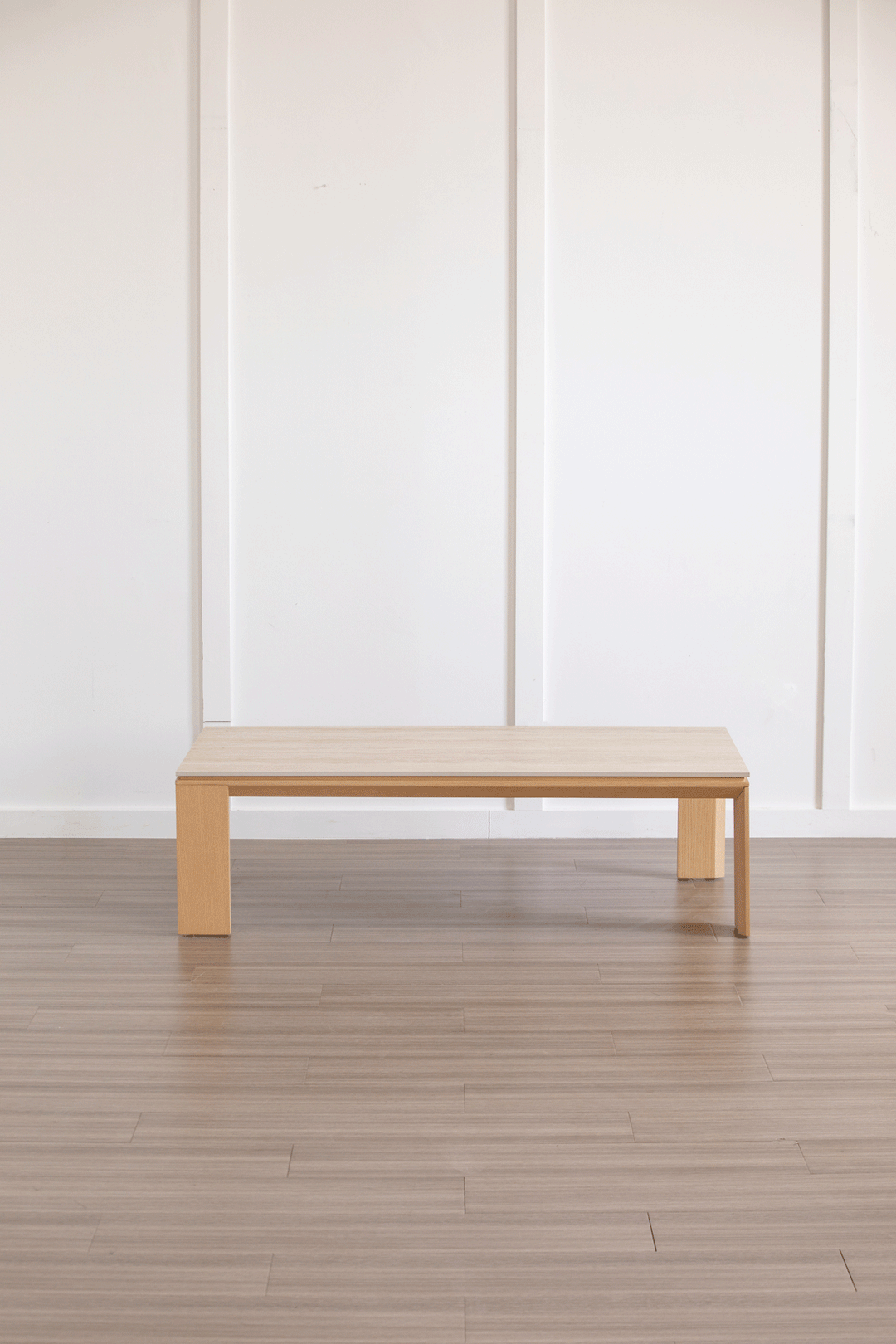 Minimalist ash wood veneer sintered stone coffee table string color swatches.