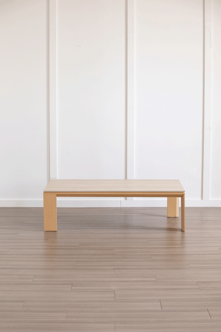 Minimalist ash wood veneer sintered stone coffee table string color swatches.