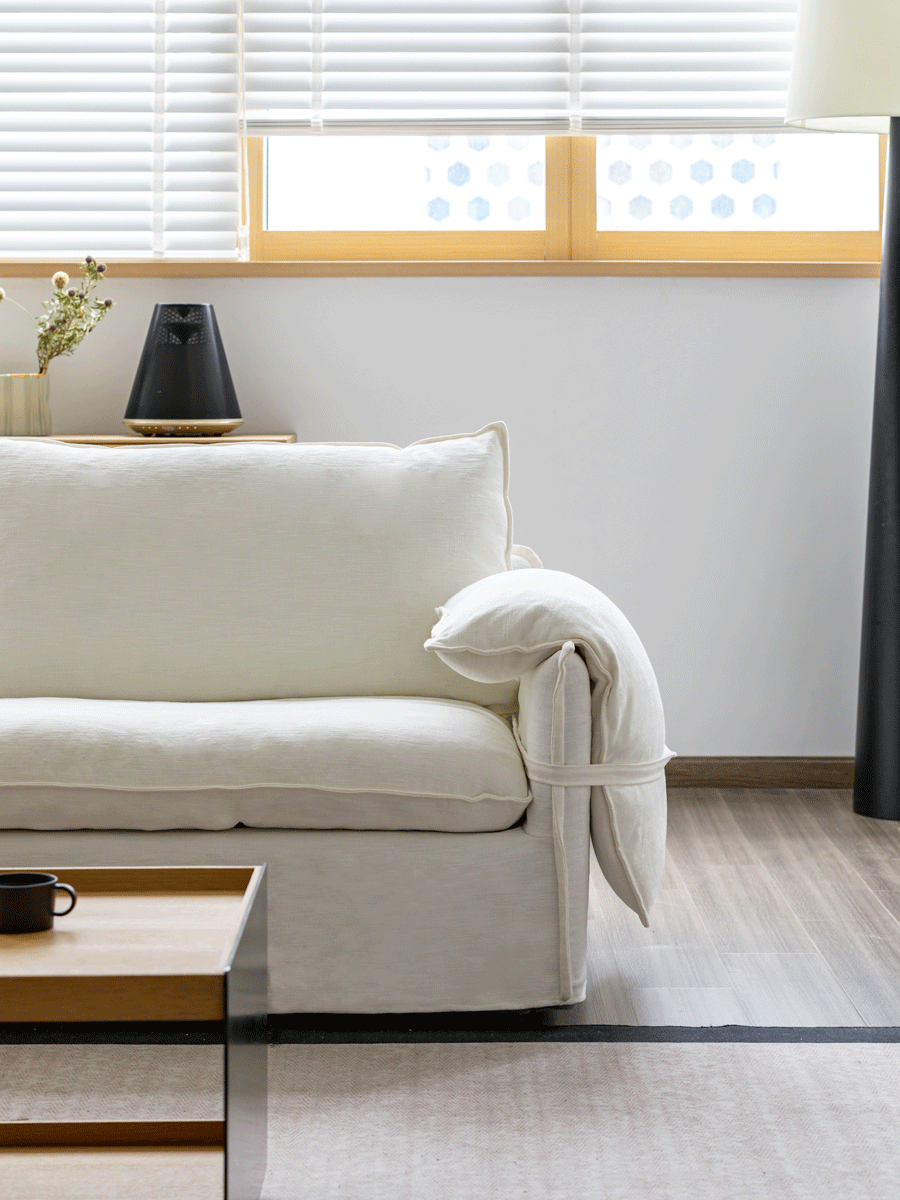 Cream cotton fabric 4 seater sofa folding ear with context.