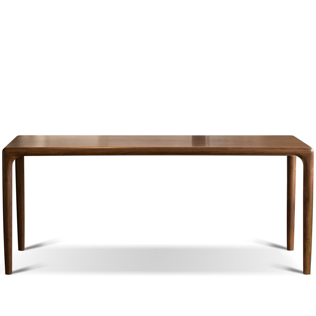 Mininalist walnut wood dining table conti in white background.