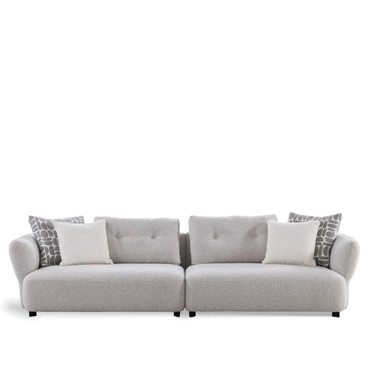Modern boucle fabric 4 seater sofa couch in white background.