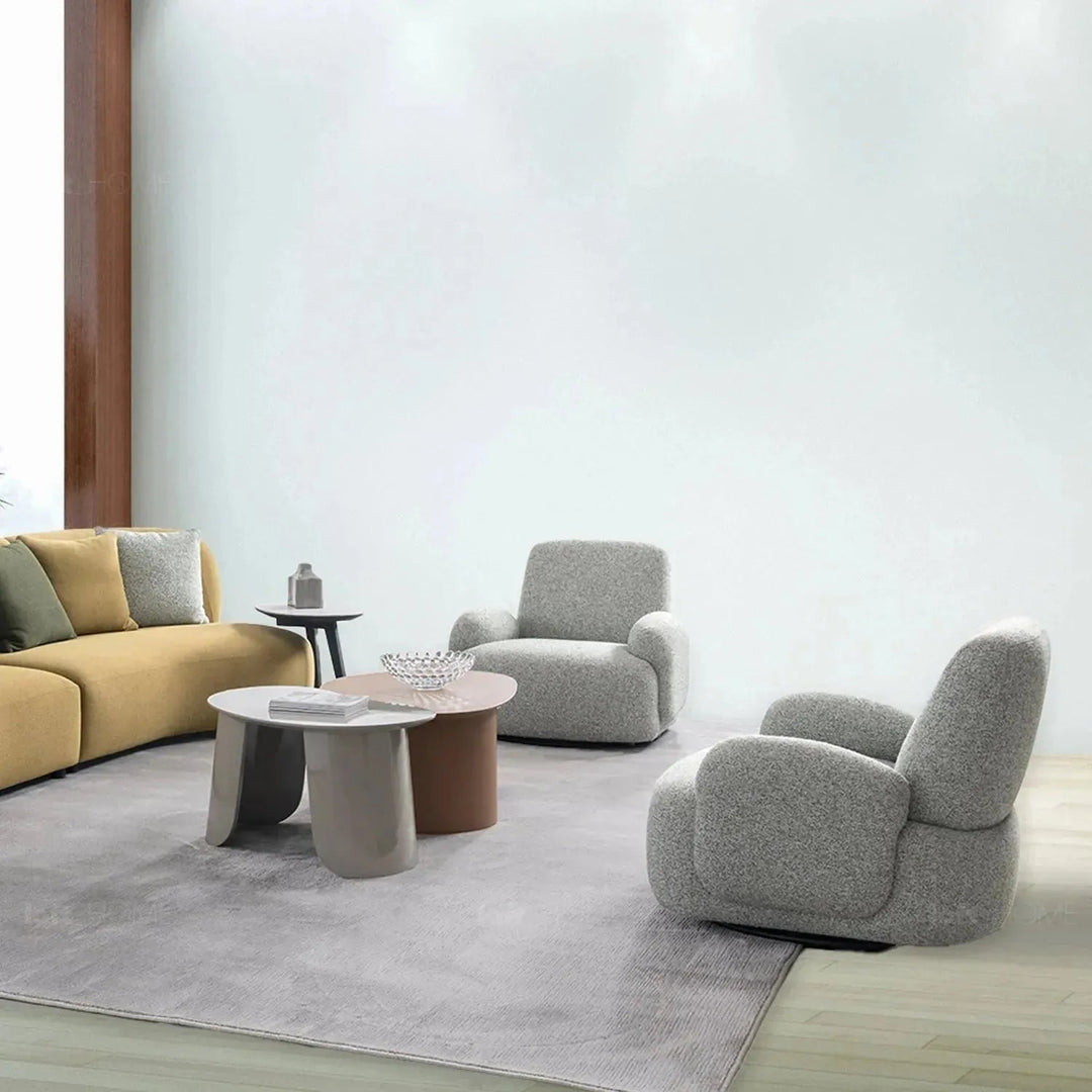 Cream mixed weave fabric revolving 1 seater sofa parapet in details.