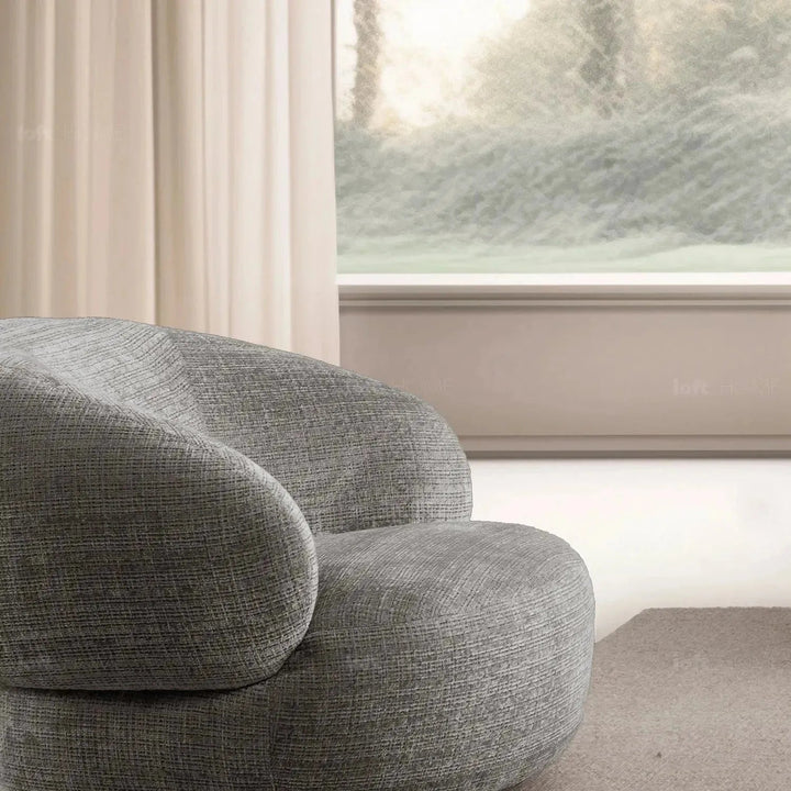 Cream mixed weave fabric revolving 1 seater sofa criet in close up details.