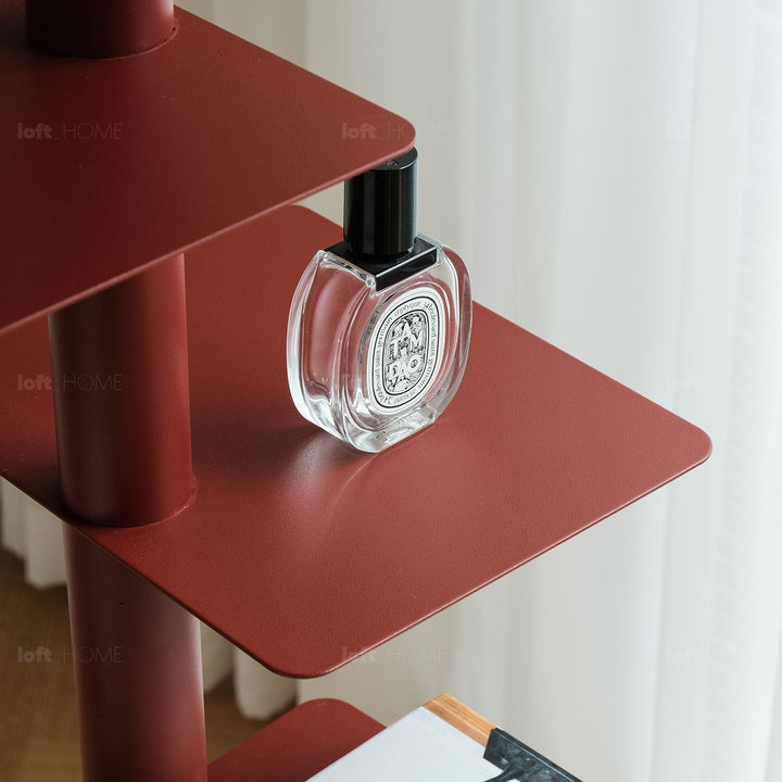 Minimalist steel revolving bookshelf stack in real life style.