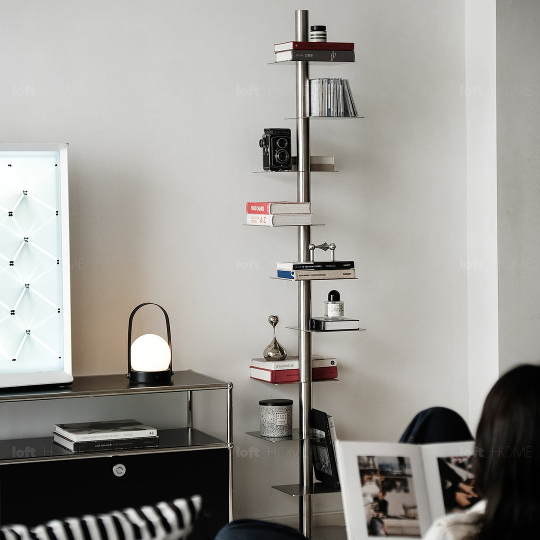 Minimalist steel revolving bookshelf stack in panoramic view.