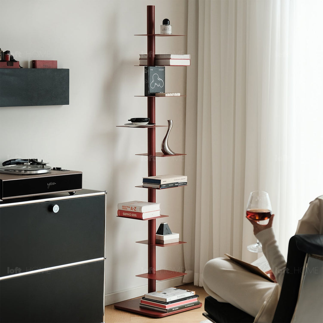 Minimalist steel revolving bookshelf stack in still life.