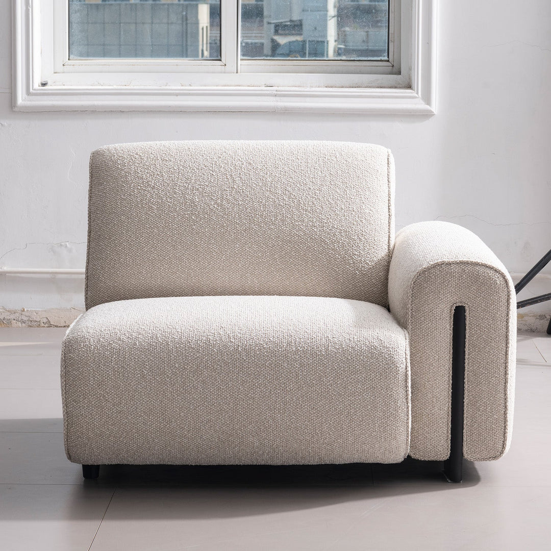 Minimalist boucle fabric modular 4 seater sofa colle in close up details.