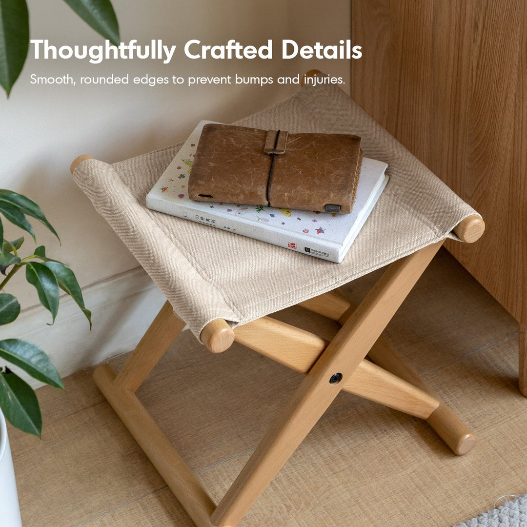 Scandinavian beech wood canvas folding stool kaya in panoramic view.