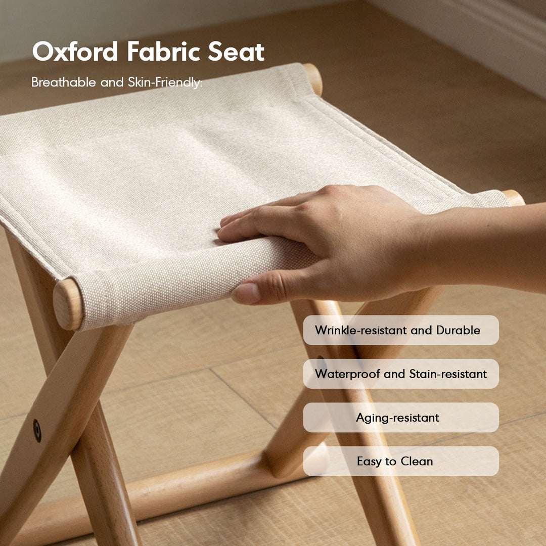 Scandinavian beech wood canvas folding stool kaya in close up details.