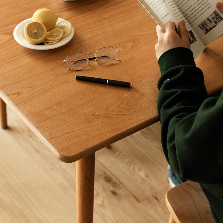 Scandinavian cherry wood dining table green in still life.