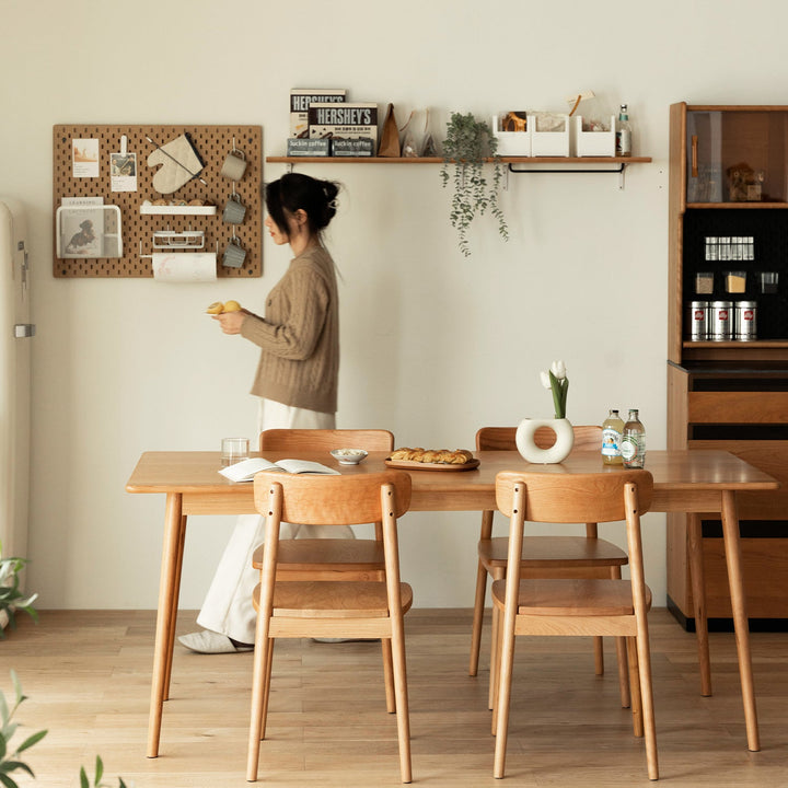 Scandinavian cherry wood dining table green in real life style.