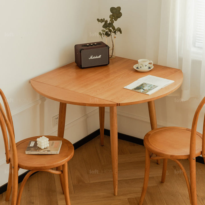 Scandinavian cherry wood extendable round dining table greekn with context.