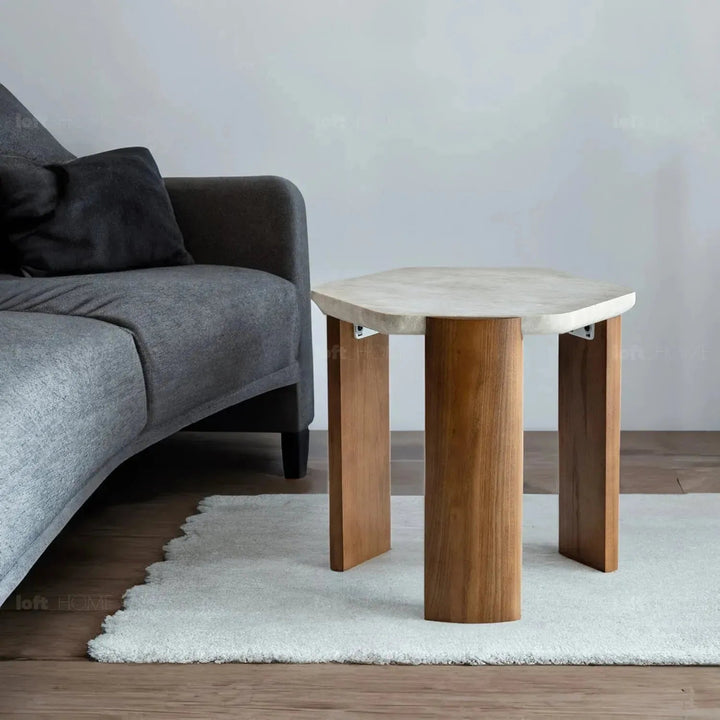 Scandinavian travertine stone side table trawo in panoramic view.