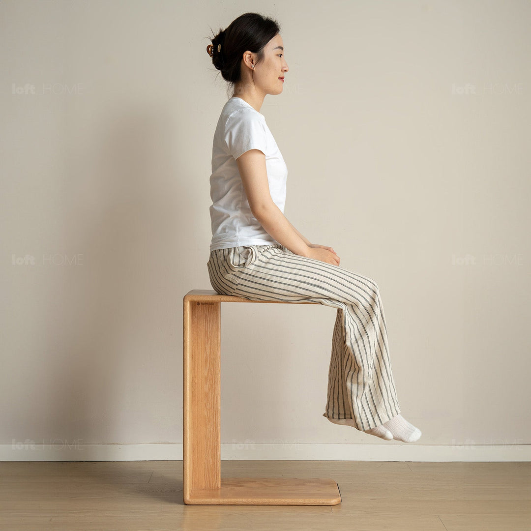 Scandinavian oak wood multi functional side table cshape in still life.