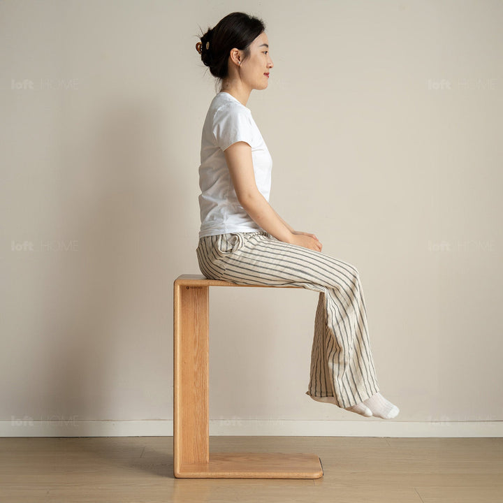 Scandinavian oak wood multi functional side table cshape in still life.