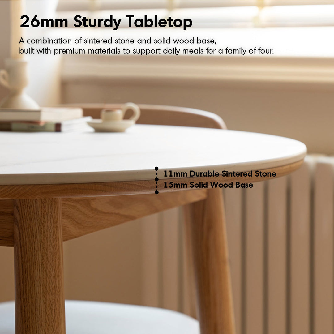 Scandinavian oak wood sintered stone round dining table orb in still life.