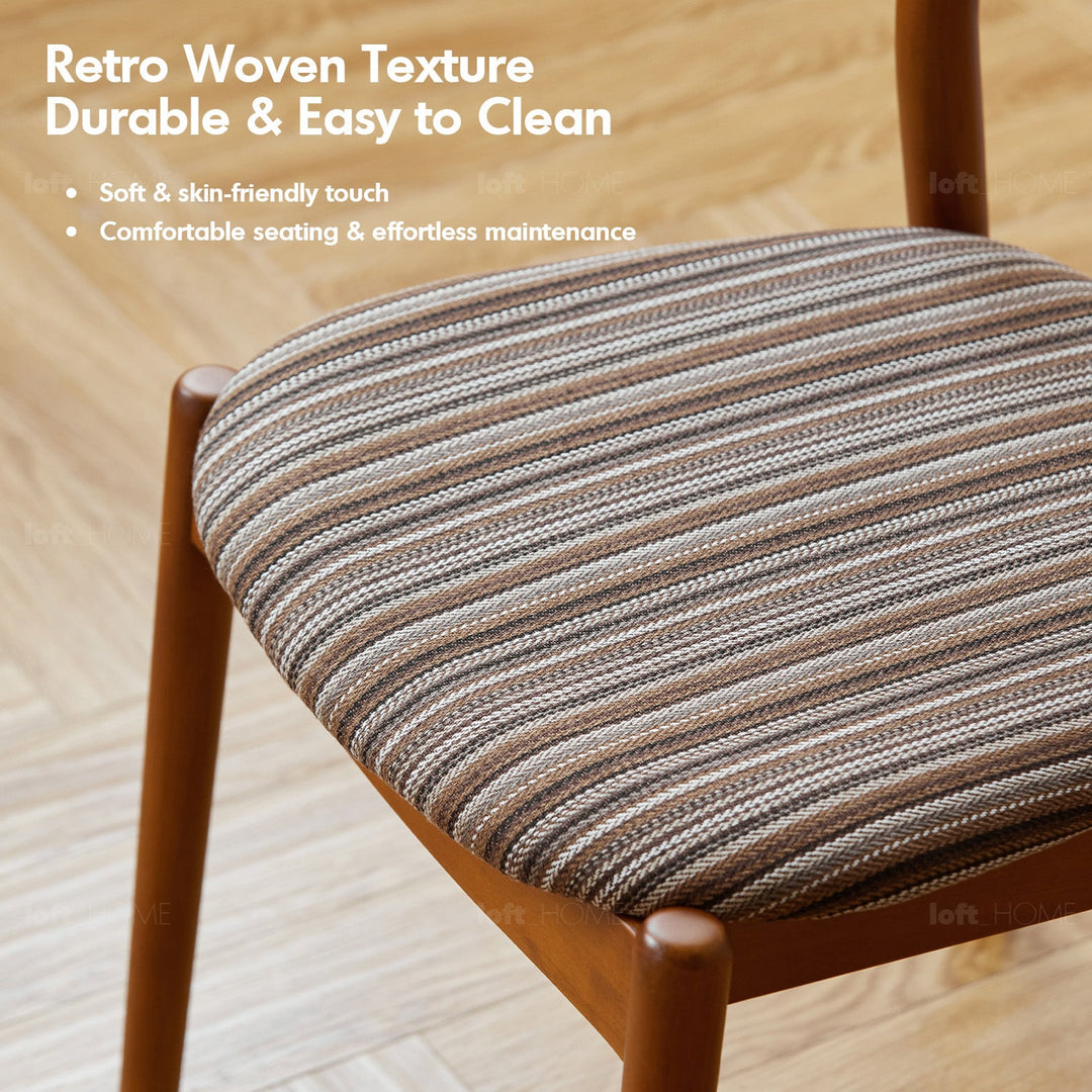 Bauhaus boxwood mix weave fabric cushion stackable dining chair truffle in still life.