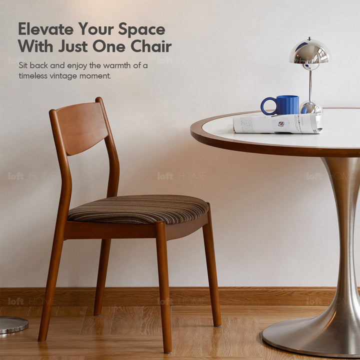 Bauhaus boxwood mix weave fabric cushion stackable dining chair truffle in real life style.