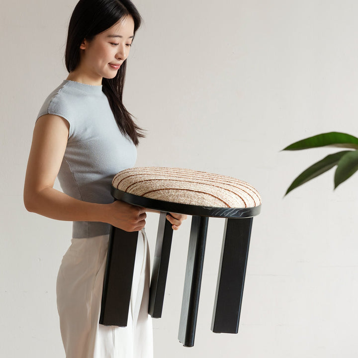 Bauhaus ash wood boucle fabric stool orbit in still life.