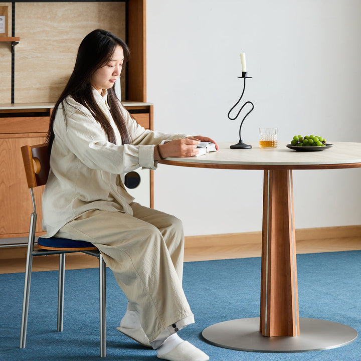 Bauhaus cherry wood sintered stone round dining table pinecone with context.