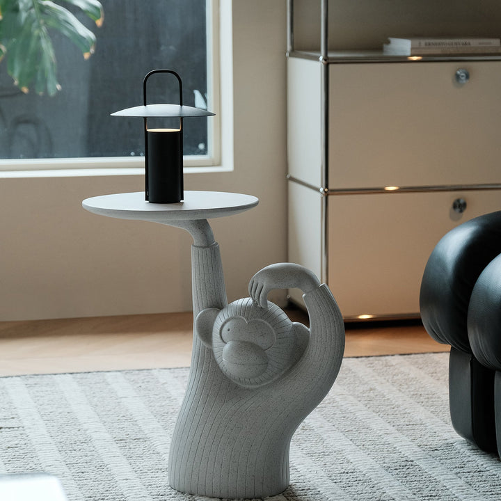 Contemporary fiberglass side table monkey material variants.