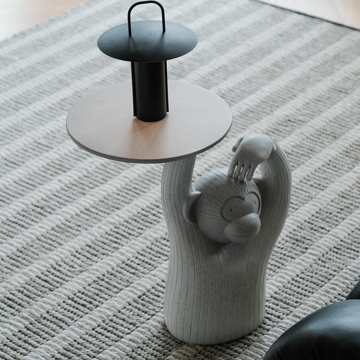 Contemporary fiberglass side table monkey with context.