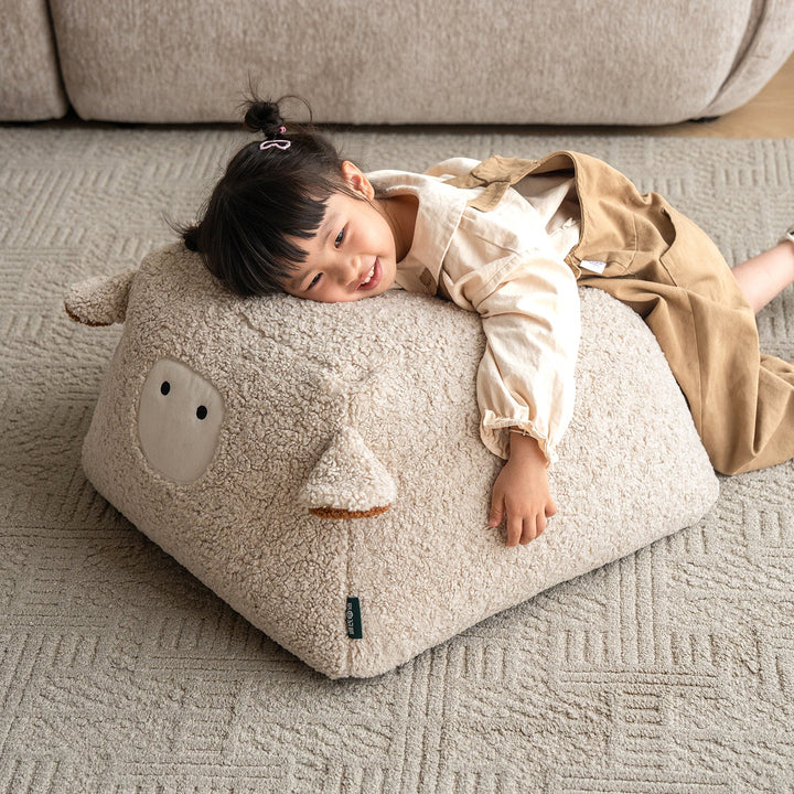 Cream boucle fabric ottoman sheep primary product view.